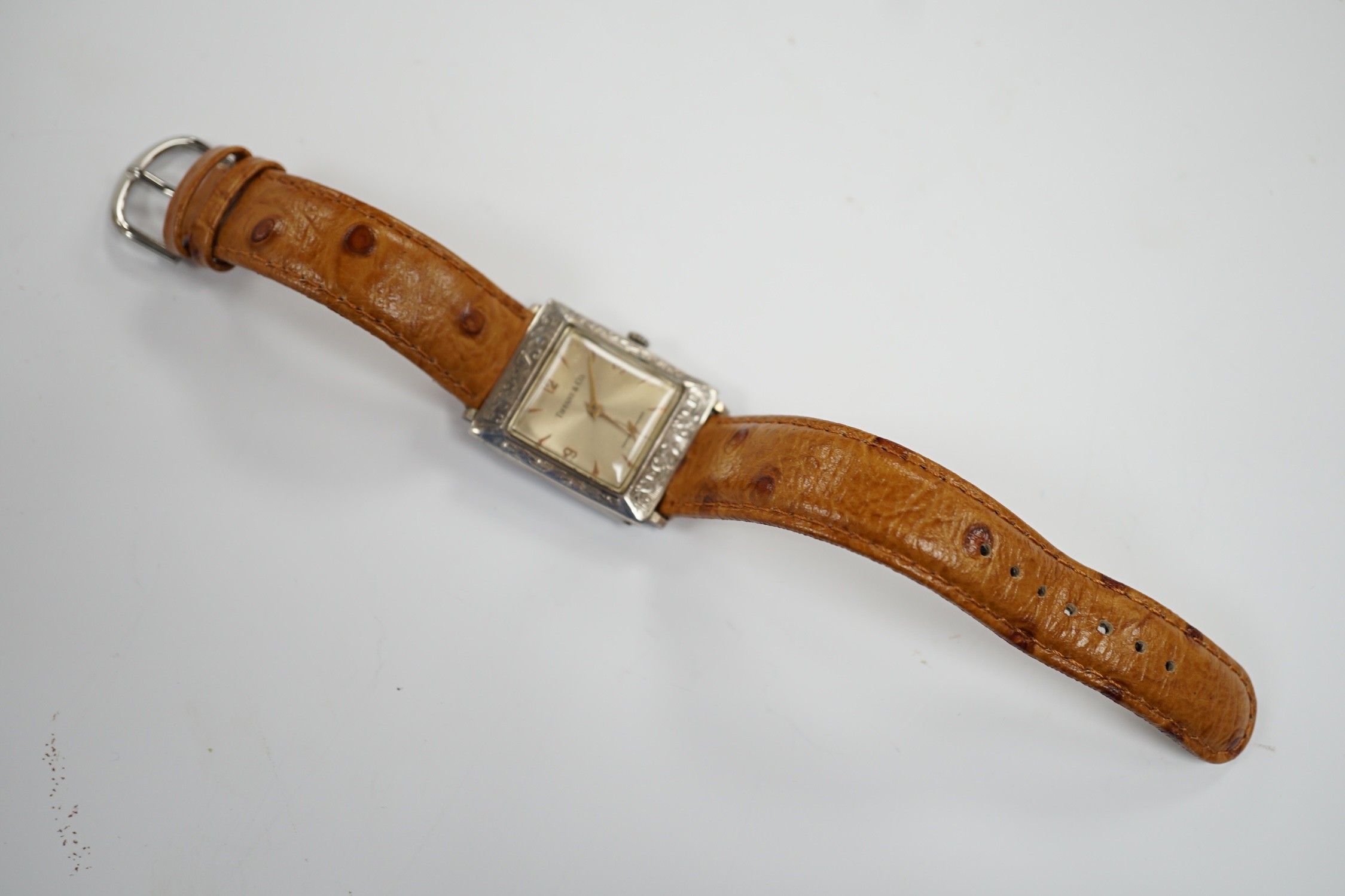 A German sterling manual wind dress wrist watch, retailed by Tiffany & Co, with baton and quarterly Arabic numerals, on an associated leather strap.